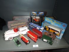 A collection of model buses and cars, some in boxes.
