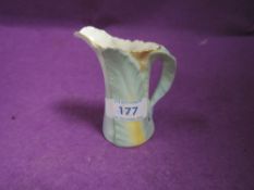 A Royal Worcester creamer having naturalistic design on Green back stamp