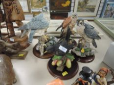 A collection of bird figurines,country artists kestrel,two Peregrine falcons and a thistle green