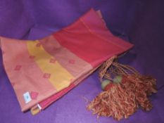 A set of Dorma curtains and tie backs in pinks and oranges.