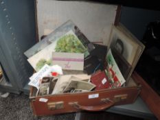 A vintage suitcase containing collection of ephemera,books,postcards(some slightly risqué)and more,