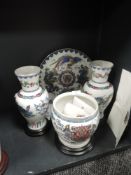 A collection of vases, a planter and charger with stands,having Chinese design with gilt detailing,