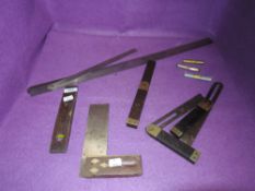 A selection of wood or cabinet makers marking and measuring devices including rulers and bevel