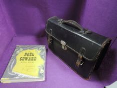 A selection of piano sheet music and Noel Coward song book with leather bound satchel