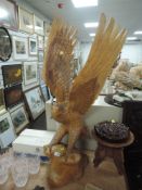 An impressive hand carved wooden figure of an American Bald Eagle standing at 87cm approx