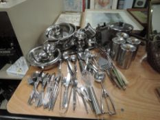 A large lot of kitchen utensils.