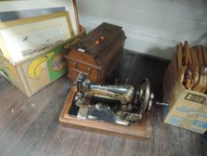 An antique hand cranked sewing machine by Singer 15033657 with case