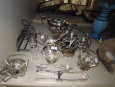 A mixed lot of plated ware and stainless items,including asparagus tongs and toast rack.