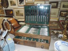 A vintage oak canteen with draw and a selection of plated and stainless steel cutlery.