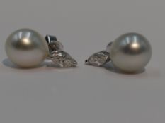 A pair of marquise cut diamond, each approx 0.25ct and South Sea pearl stud earrings in 18ct white
