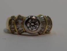 A lady's dress ring having a central diamond, approx 0.5ct to baguette diamond set stepped fanned