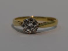 A lady's diamond solitaire dress ring, approx 0.75ct in a claw set mount to raised shoulders on an