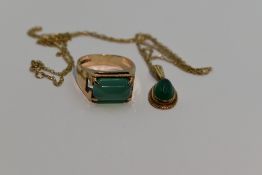 A green cabouchon pendant of oval form in a 9ct gold mount on a 9ct gold chain, approx 18' with a
