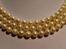 A mid 20th Century triple row cultured pearl necklace, each pearl of even form having decorative