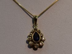 A sapphire and diamond teardrop cluster pendant in a yellow metal mount, marks worn, probably 18ct