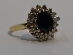 A lady's dress ring having a sapphire and diamond oval cluster having brilliant cut and baguette cut