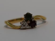 A lady's dress ring having a diamond,emerald and ruby trio, each stone approx 0.125ct in claw set