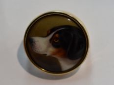A Victorian ceramic brooch depicting a dog possibly a hound in profile signed W Essex 1854 to