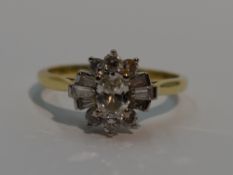A lady's dress ring having a diamond cluster with central oval diamond surrounded by baguette and