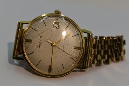 A gents Marvin automatic 18ct gold wrist watch,no:90837, having a baton numeral dial with date