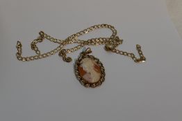 A conche shell cameo pendant depicting a maiden in profile in a 9ct gold mount with 9ct gold