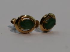 A pair of 9ct gold stud earrings having jade style oval stones