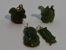 Four carved jade charms including elephant and squirrel