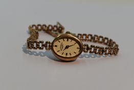 A lady's 9ct gold wrist watch by Rotary having a baton numeral dial to obval face on a 9ct gold