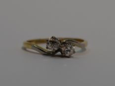 A lady's dress ring having a duo of diamonds, total approx 0.5ct in claw set mount, to cross over