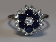 A lady's dress ring having a diamond and sapphire triple cluster, total weights approx 0.80ct