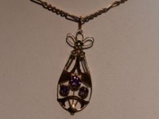 An Edwardian rose gold Art Nouveau style pendant stamped 9ct having amethyst and seed pearl