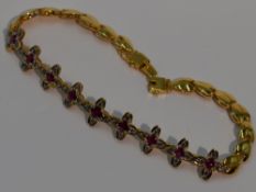 An Oriental ruby and diamond bracelet modelled as a string of four petal interlinked flowers on a