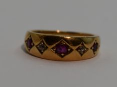 A lady's dress ring of band form having a trio of rubies interspersed by two diamonds in square