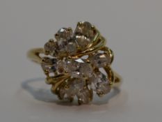 A lady's dress ring having a ten stone cubic zirconia open cluster in a stylised mount on a 14ct
