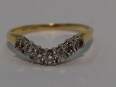 A lady's shaped half eternity ring having seven diamonds, total approx 0.35ct in a curved claw set