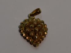 An Oriental gold pendant in the form of a 3D heart, bearing marks and tested as 22ct gold, approx