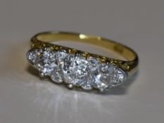 A Victorian lady's dress ring having three graduated diamonds with a border of six diamond chips,