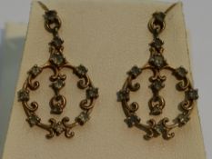 A pair of 9ct gold stud earrings having ornate drops with alexandrite stone decoration, with Gems TV