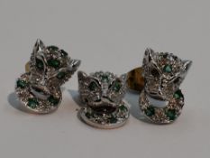 A pair of 9ct white gold stud earrings in the form of gem set leopard heads with a matching pendant,