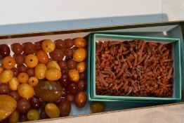 A small selection of loose beads including Butterscotch Amber, coral branch, Carnelian etc