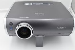 A Canon XEED SX50 multimedia projector with remote control in a Pelican 1600 hard case