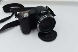 A Nikon L100 digital camera with user manual