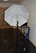 A selection of lighting equipment including a pair of Lastolite collapsable reflectors with tripod