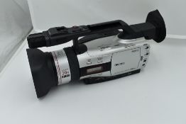 A Canon XM2 3CCD digital camcorder with Canon Fluorite 20 lens, and Canon Wide Converter WD-50,
