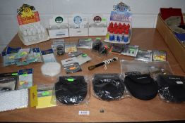 A quantity of unused fishing tackle including priests and spool pouches.