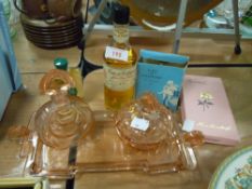 An unusual small art deco glass dressing table set in blush pink, three vintage perfumes/Eau De