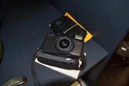 A Kodak pocket instamatic 100 and a Chinon camera.