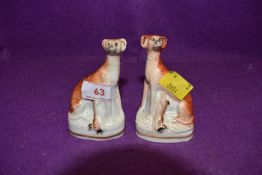 Two small vintage Staffordshire dogs, fashioned as greyhounds or similar.