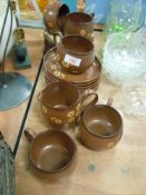 A selection of Denby tea cups and saucers in the Sandstone design