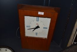 A vintage wooden cased wall clock.